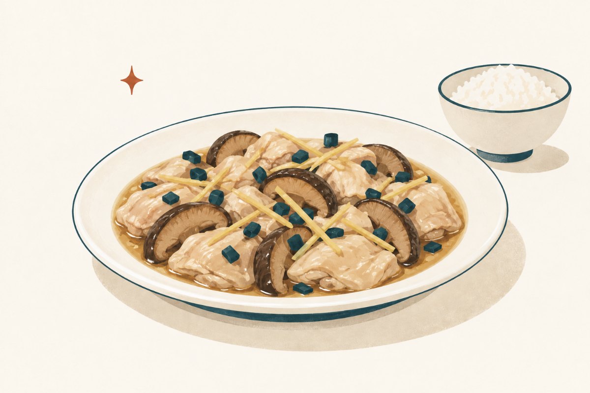 Steamed chicken thigh pieces and sliced shiitake mushrooms with ginger and scallion on a shallow white plate
